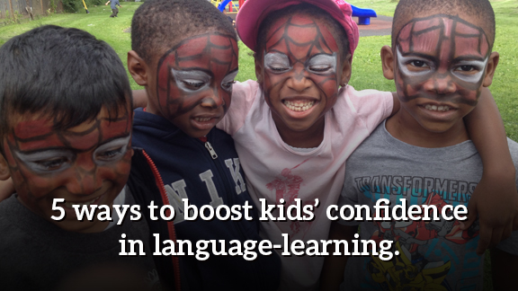 4 campers smiling with Spiderman facepaint. Text says "5 ways to boost kids' confidence in language learning."
