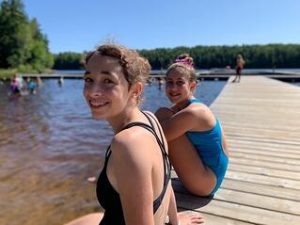 Campers smiling on lake dock